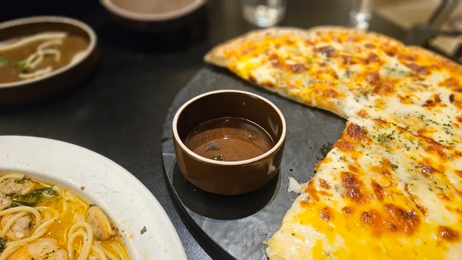 A slice of gorgonzola pizza with stretching cheese