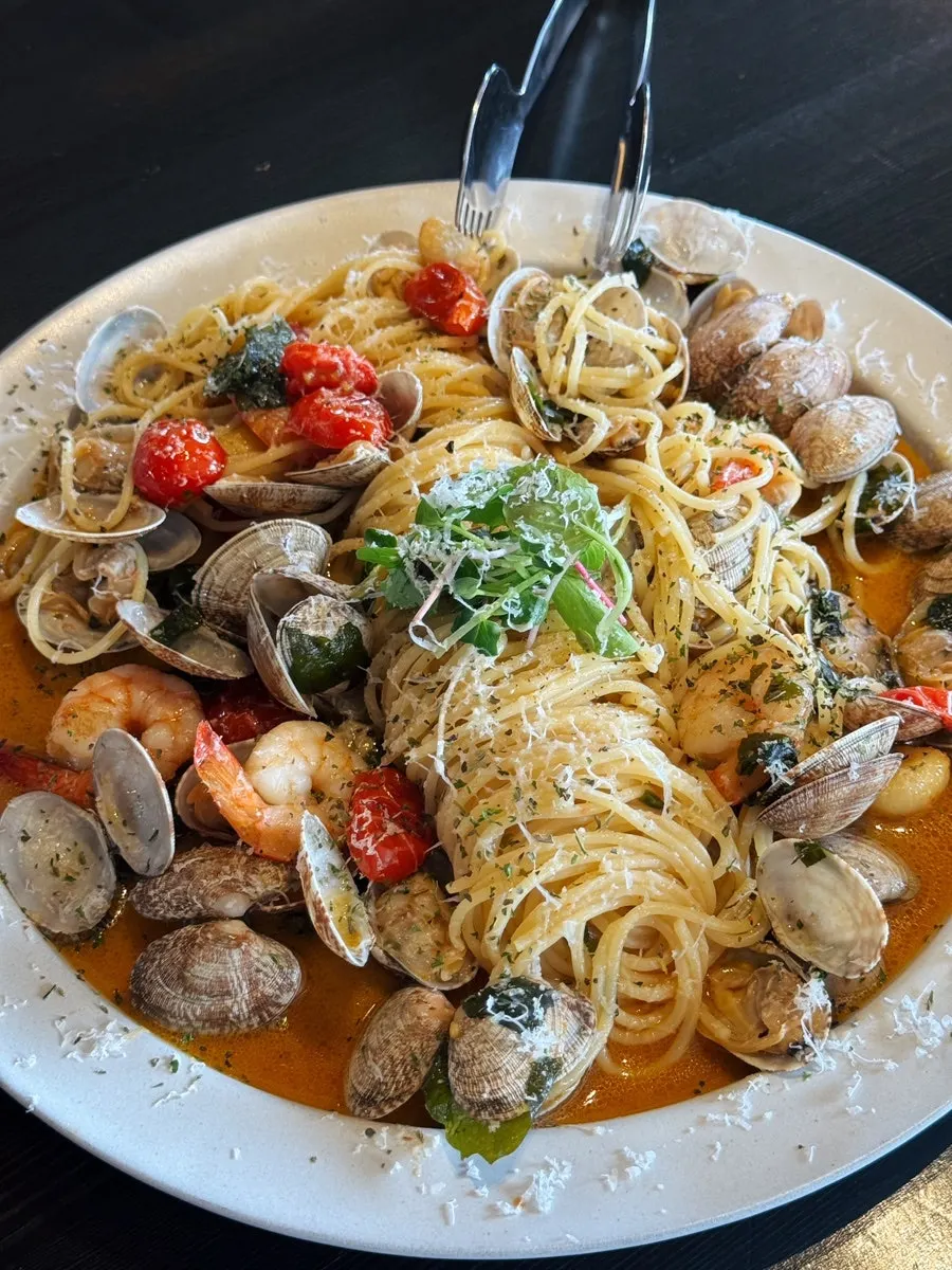 Sea Village Pasta topped with clams and shrimp