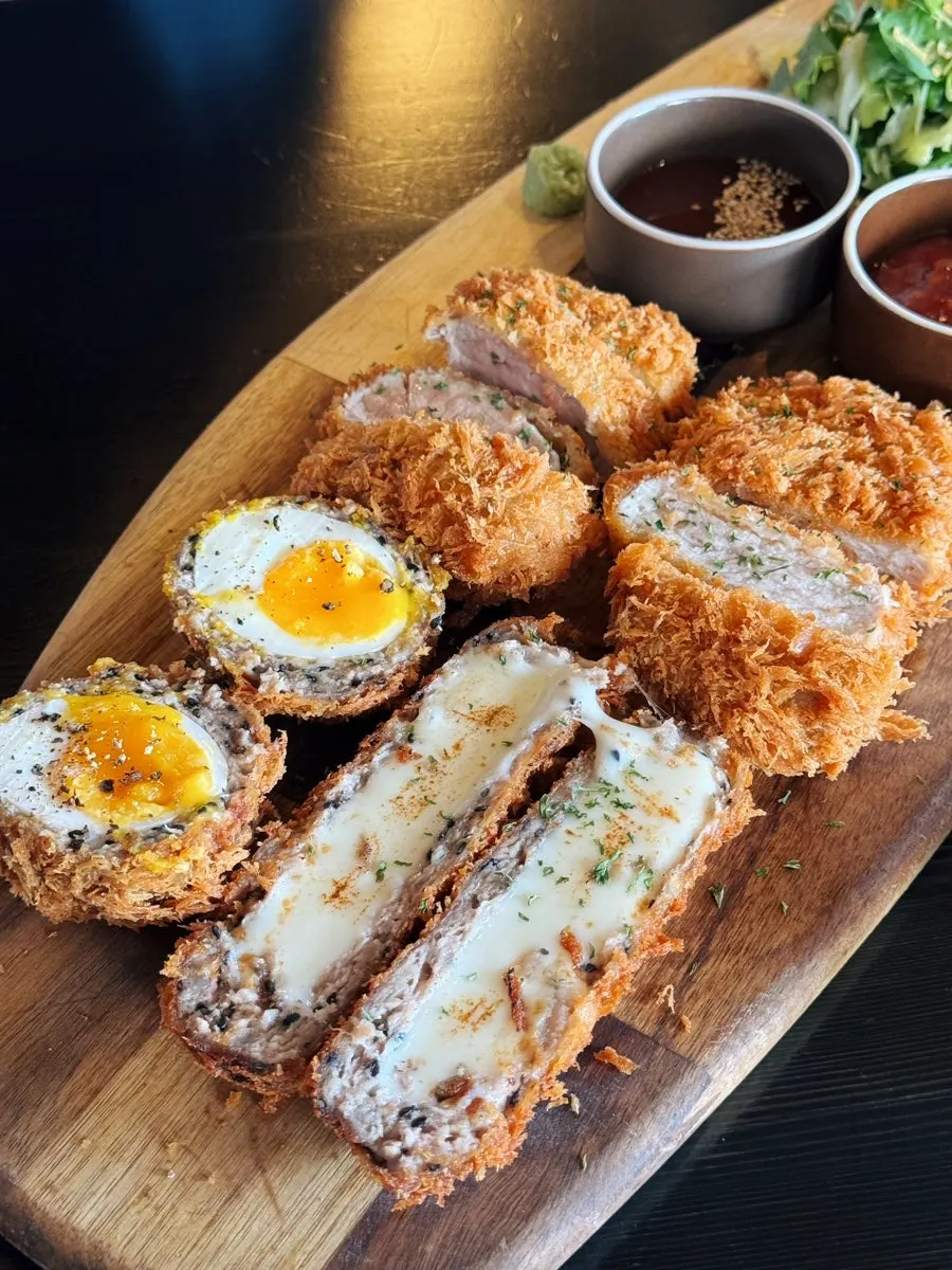 4-Katsu Platter served on a wooden board