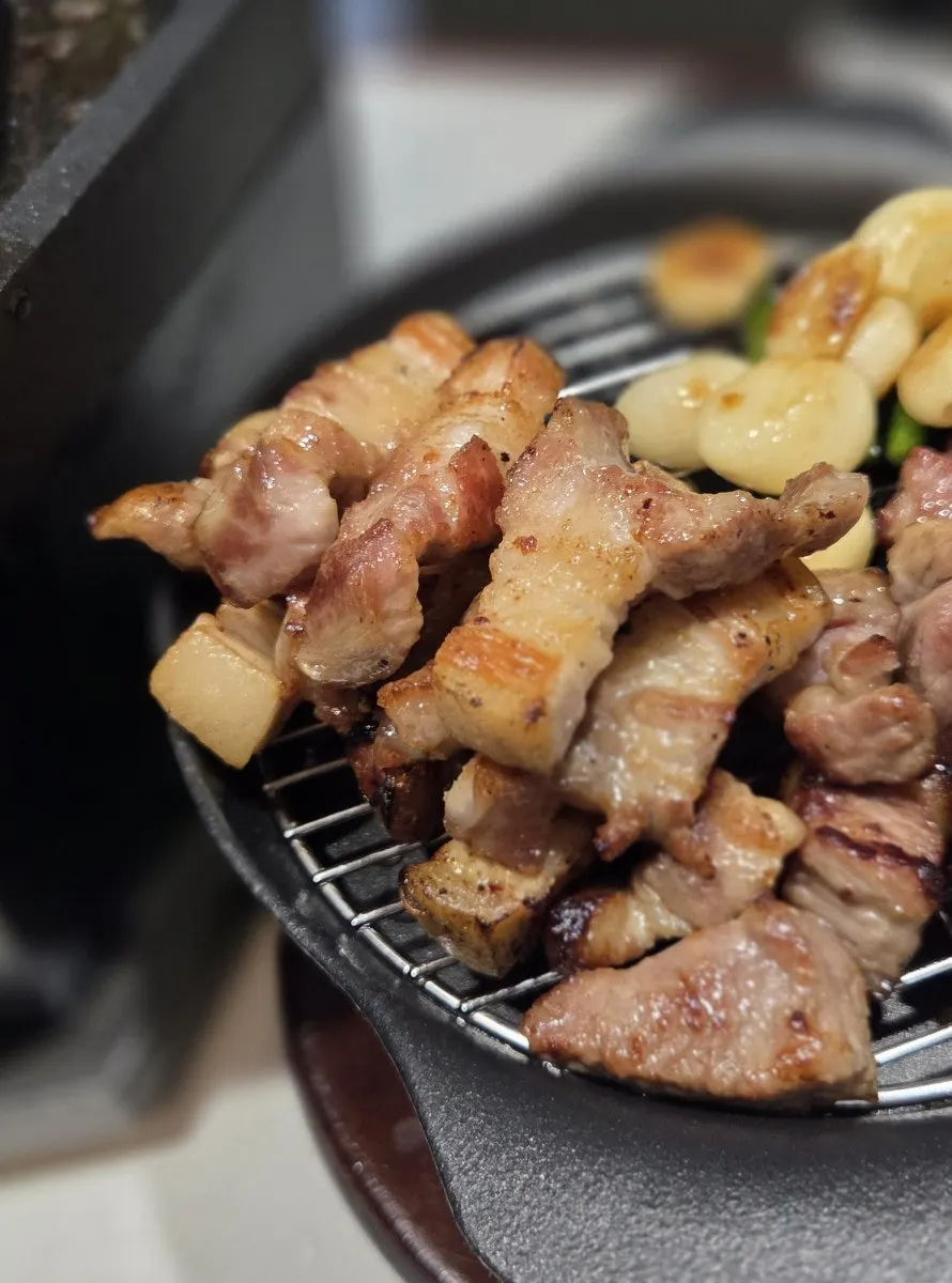 Grilled pork belly cut into bite-sized pieces