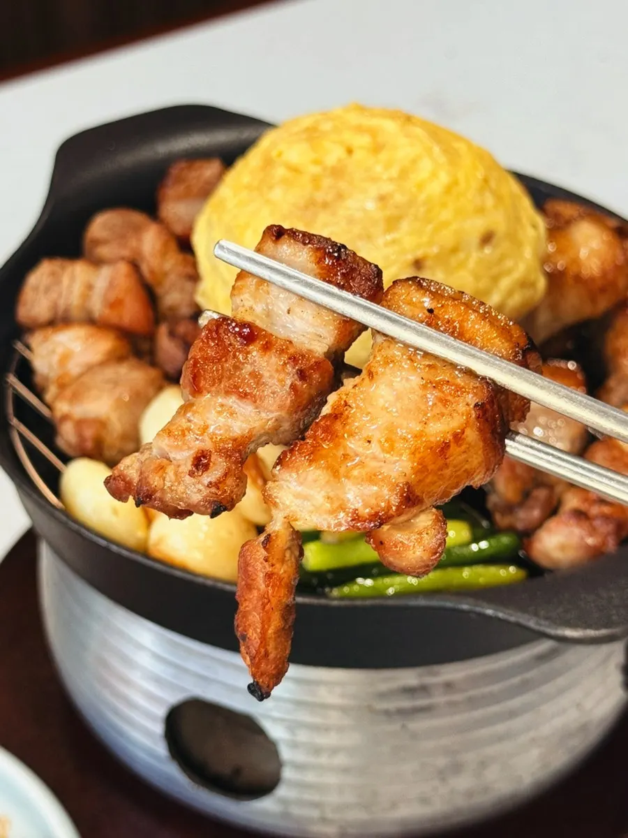 Nuruk-aged pork BBQ being eaten piece by piece