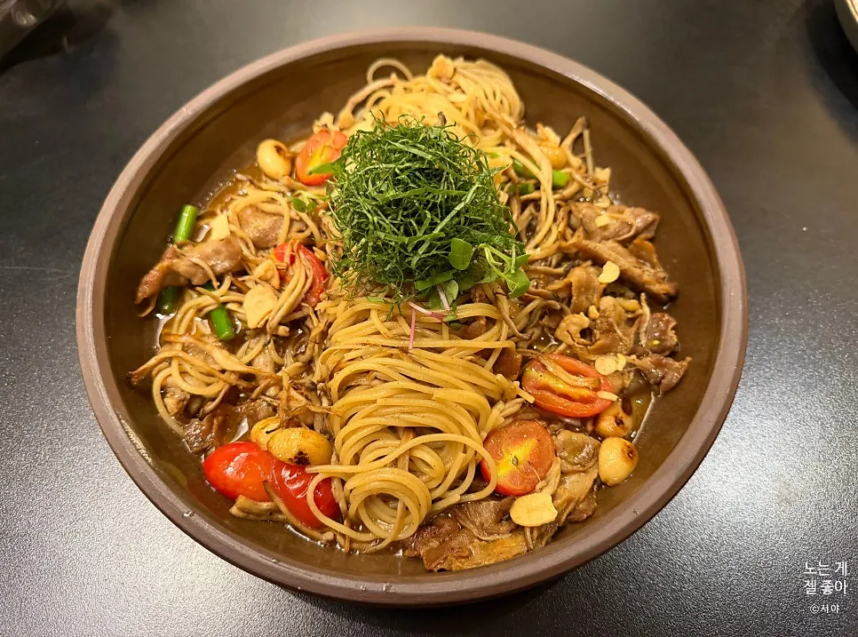 Countryside oil pasta topped with pork belly and perilla leaves