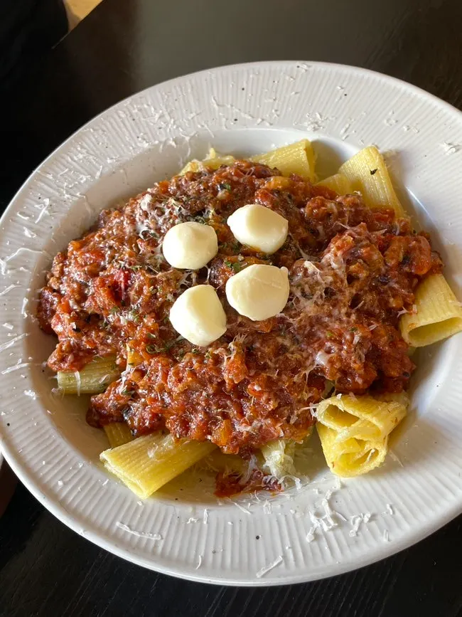 Ragu rigatoni pasta topped with mozzarella cheese
