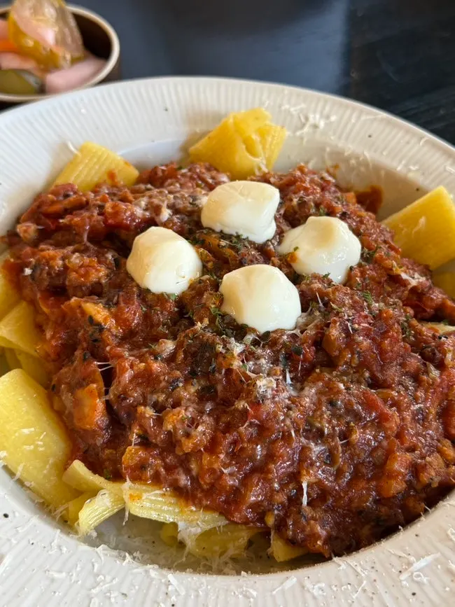 A bite of rigatoni piled high with ragu sauce