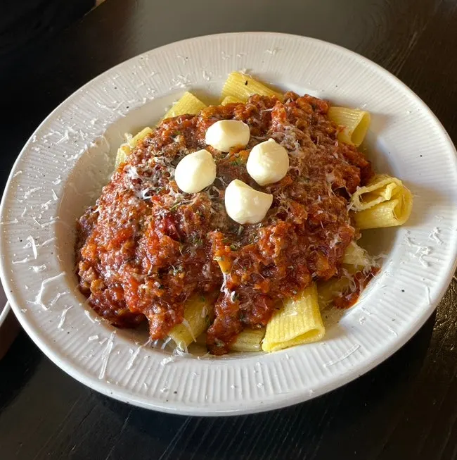 The pasta and gamdong katsu dishes served together