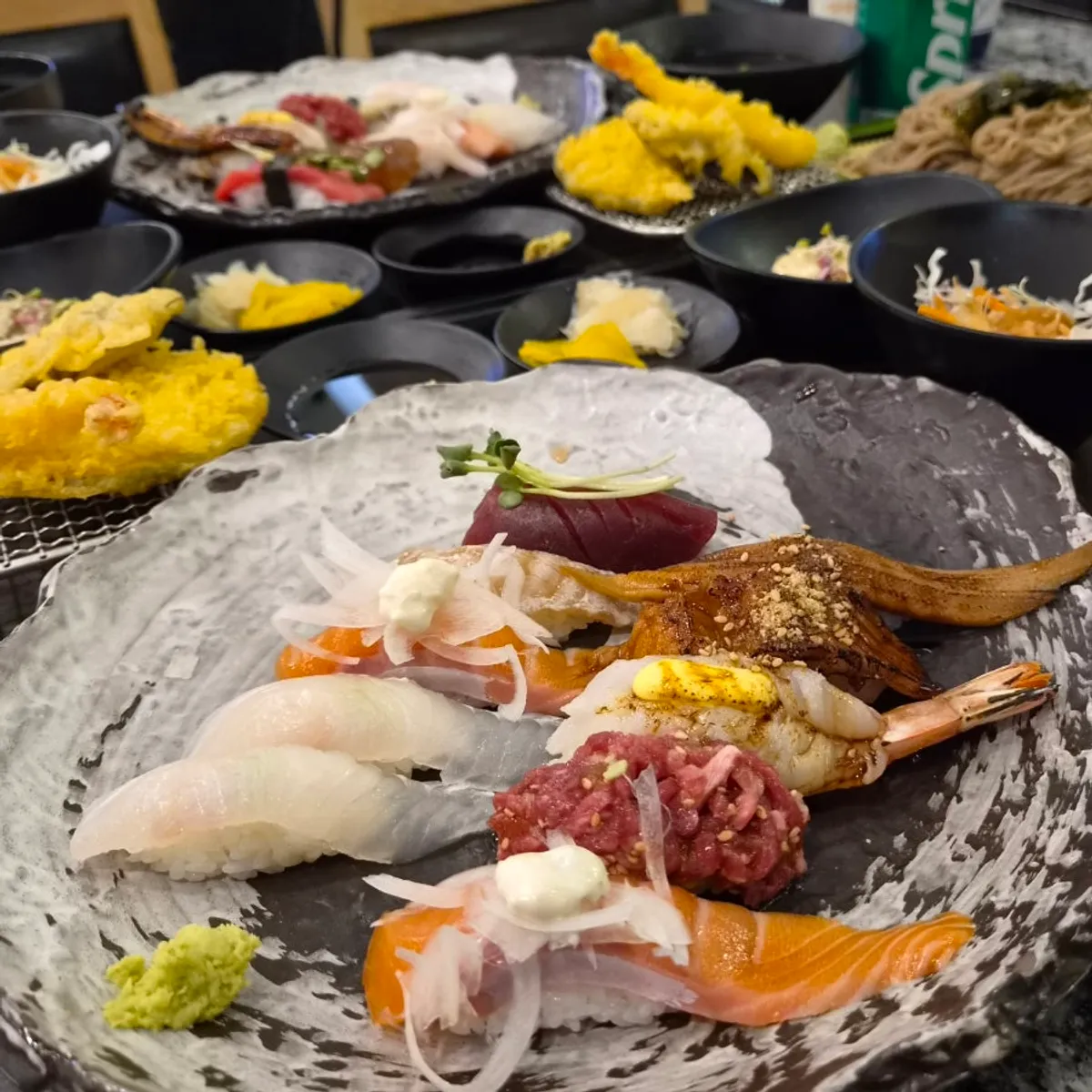 Assorted sushi with side dishes in a full spread