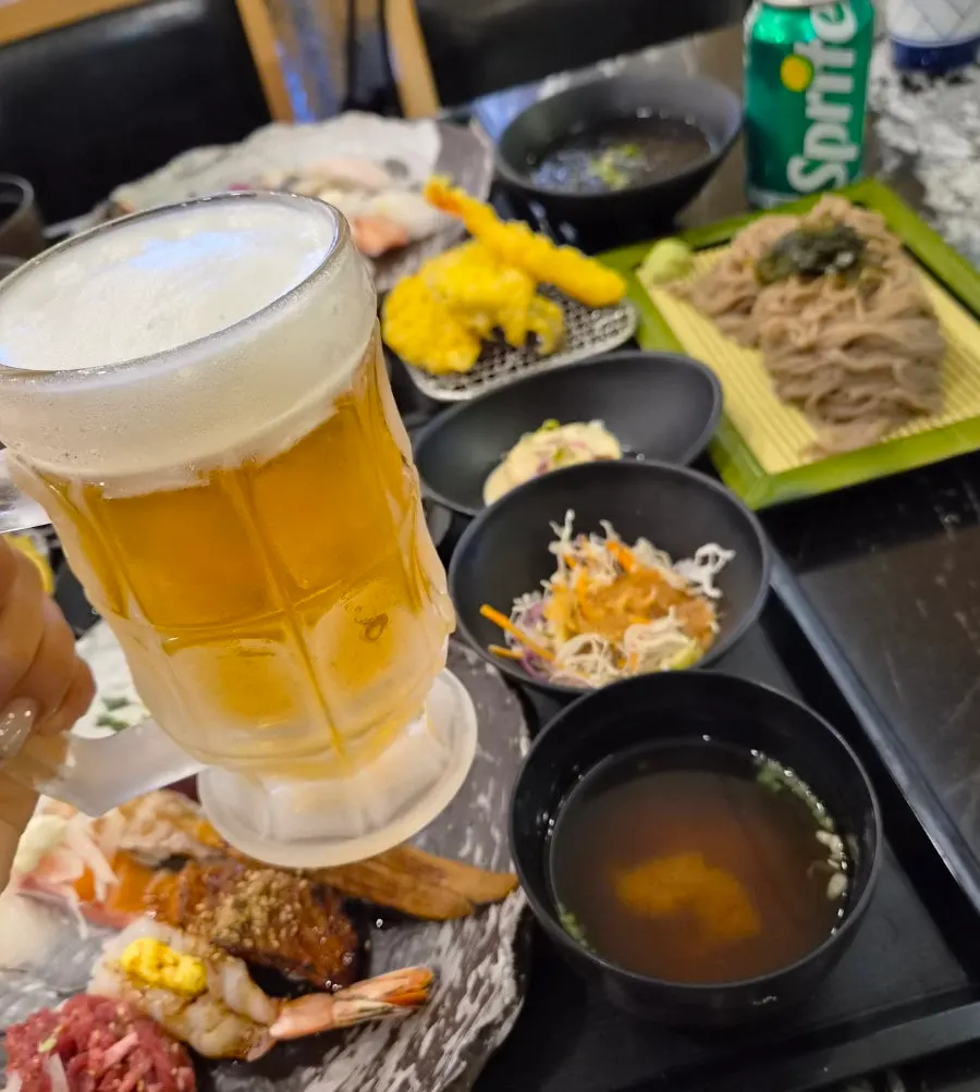 A sushi spread with draft beer