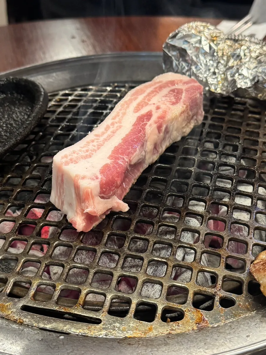 Table setup with Dongnaejeong's gabrisal and pork belly order