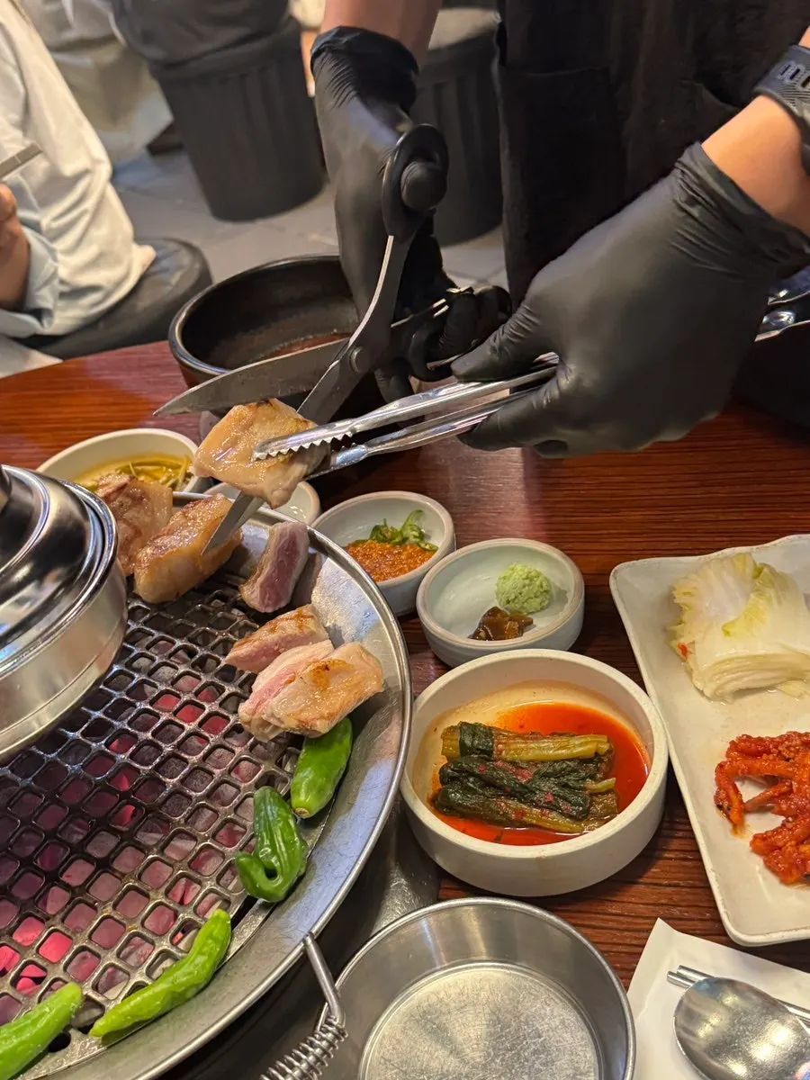 Staff grilling gabrisal at Dongnaejeong