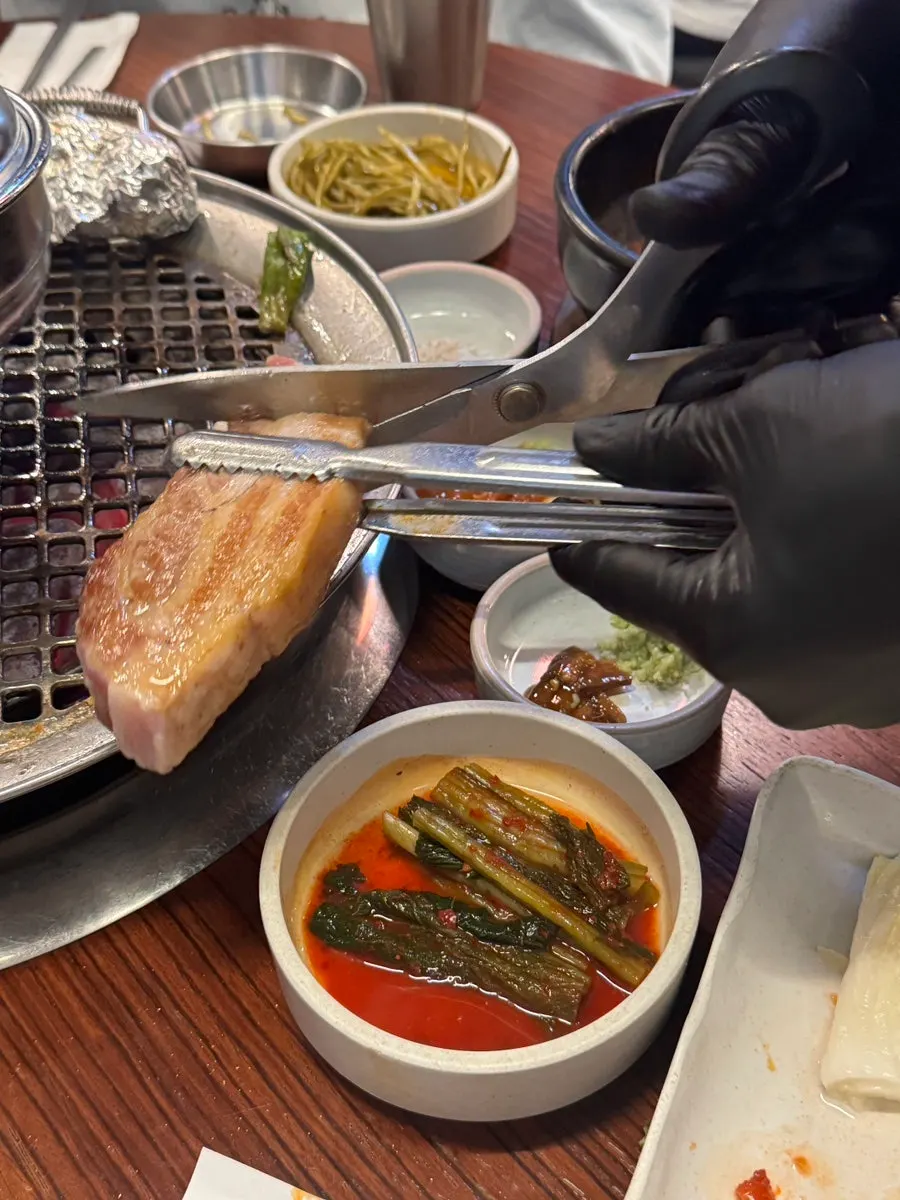 Dongnaejeong pork belly (1 serving) being grilled