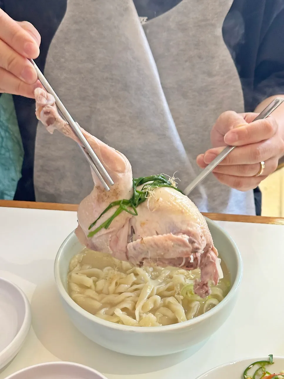 Half a chicken inside the super-concentrated samgye kalguksu