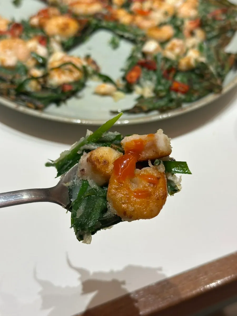 Pieces of seafood chive pancake cut with scissors