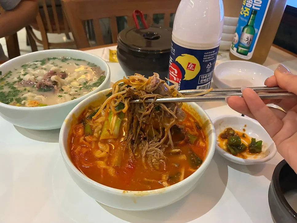 Noodles and meat lifted up together with chopsticks