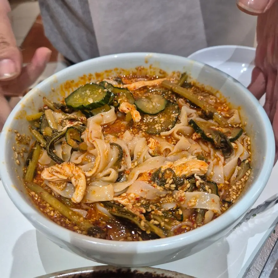 Chogye bibim kalguksu piled high with sesame seeds
