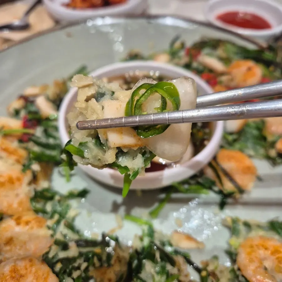 A piece of chive pancake served with onion soy sauce