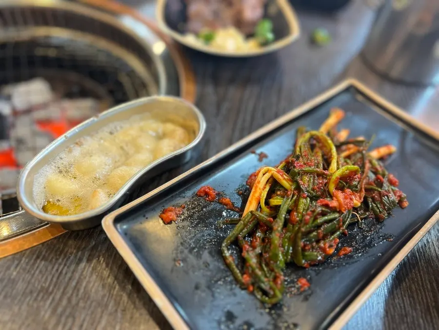 A refilled plate of green onion kimchi