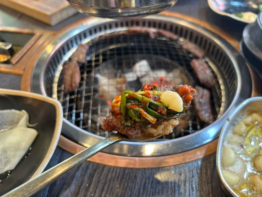A spoonful of doenjang sulbap with a piece of beef