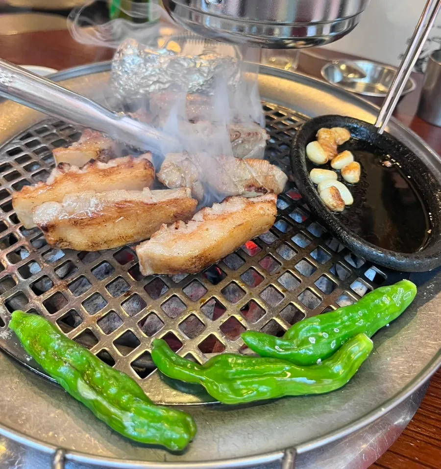 Flower pork jowl and accompaniments on the grill