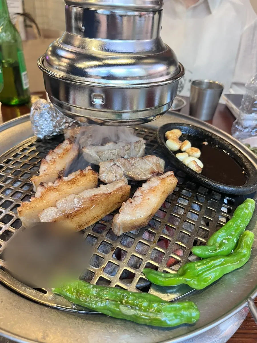 Vertical shot of pork jowl cooking