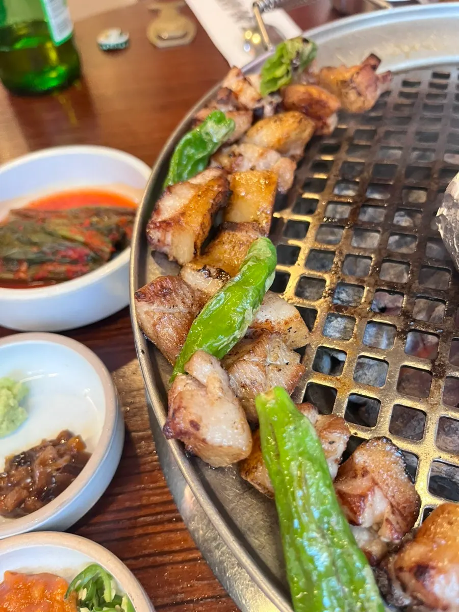 Staff member grilling the meat tableside
