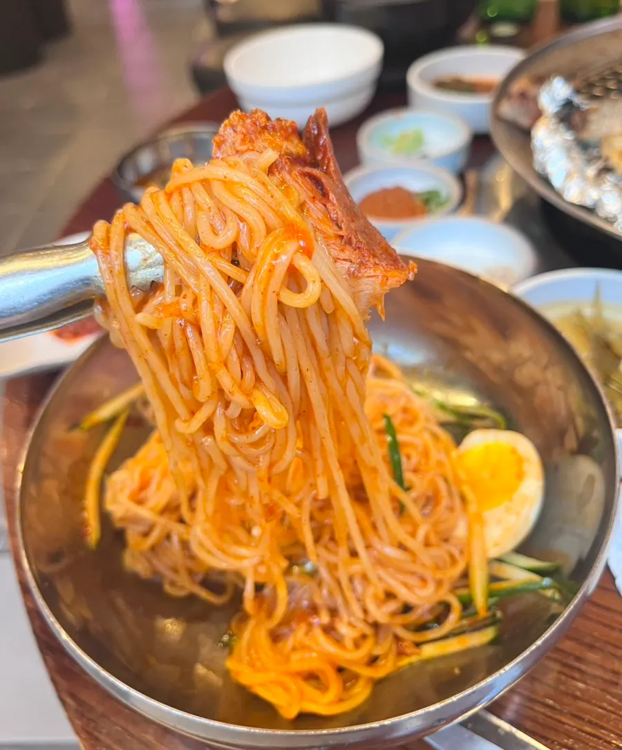 Close-up of sauce-coated bibim milmyeon noodles
