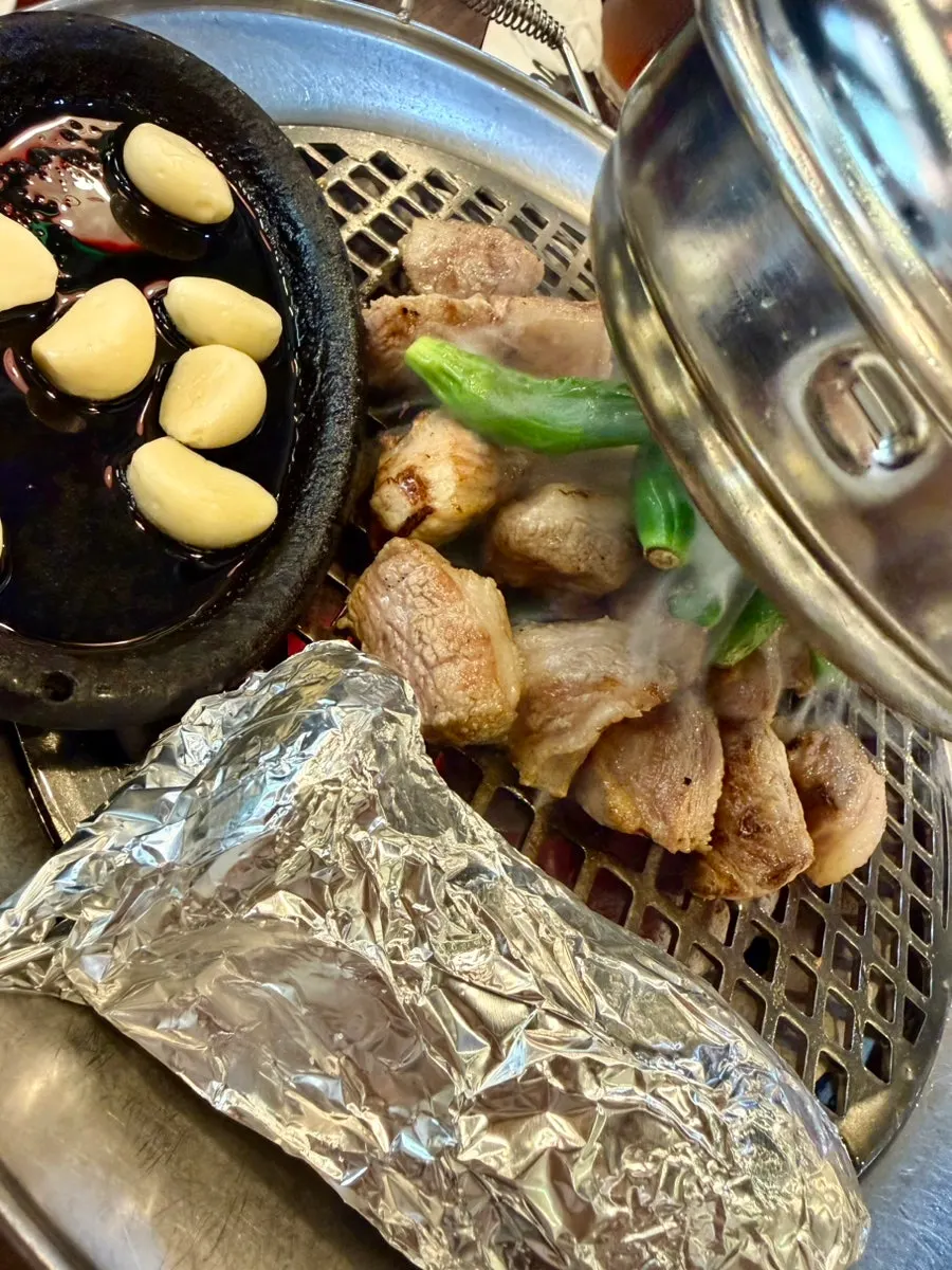 Grilled gabrisal topped with shishito peppers