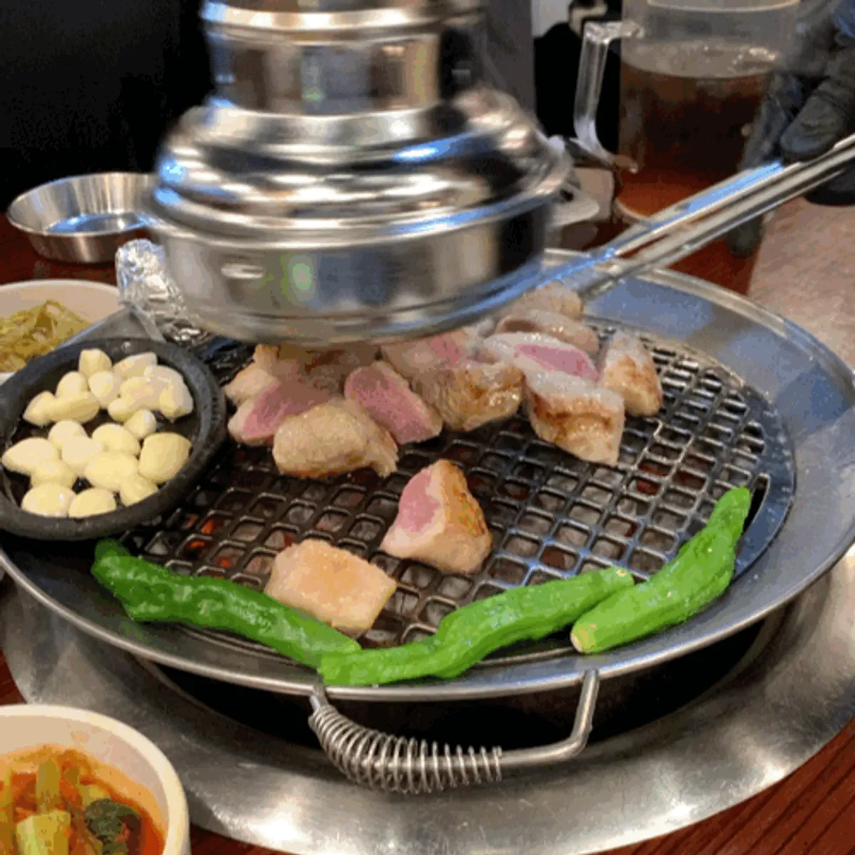 Staff member grilling the pork jowl
