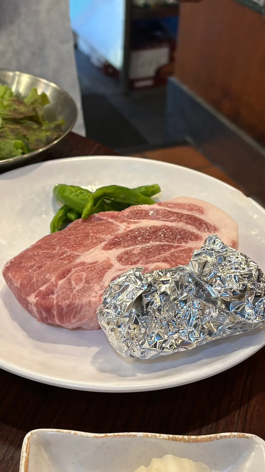 Two servings of Dongnae pork neck on the grill