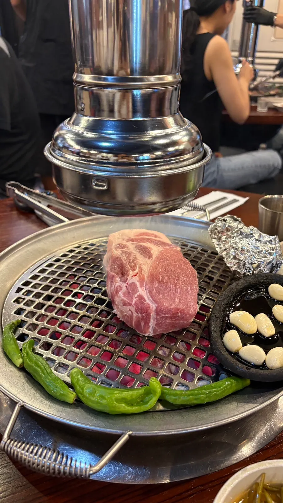 Close-up of staff grilling the pork neck