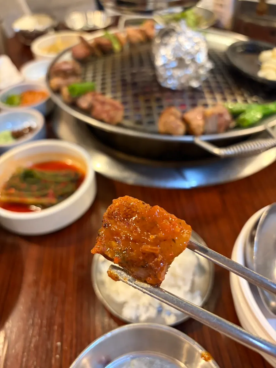 A piece of pork neck dipped in salt
