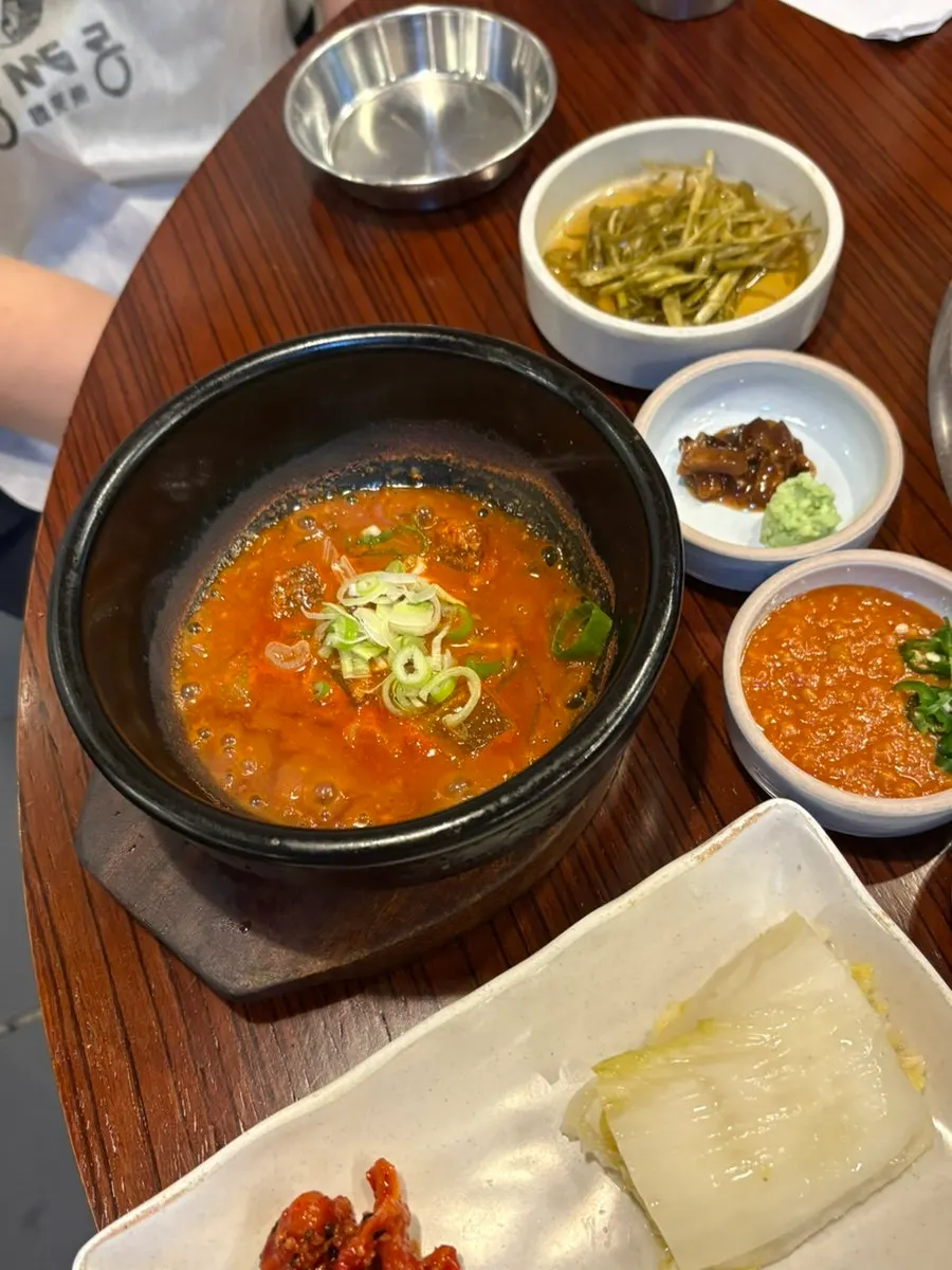 Squid rice-syrup, garlic scape salad, and mustard leaf kimchi side dishes