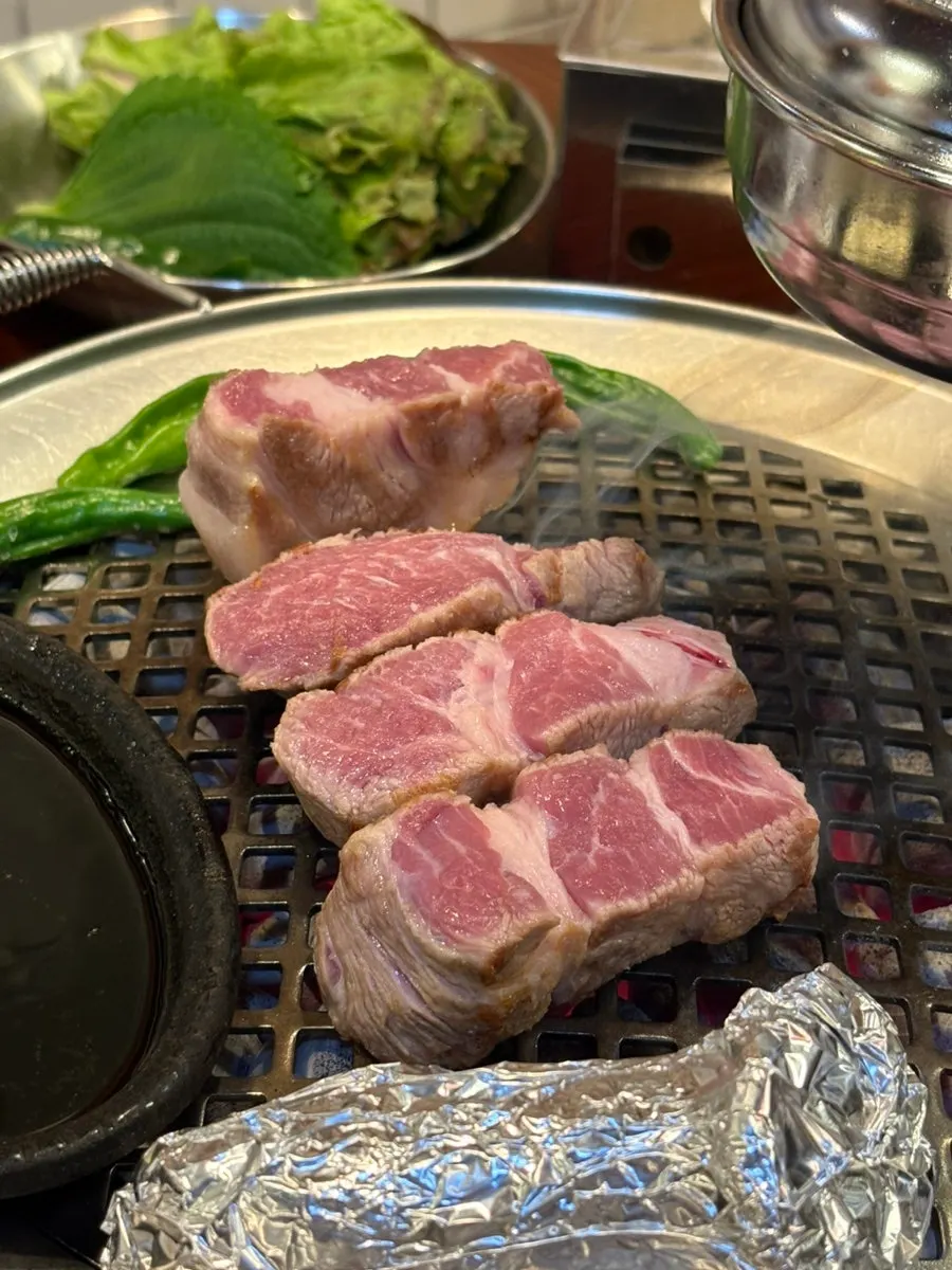 Staff grilling the thick pork neck
