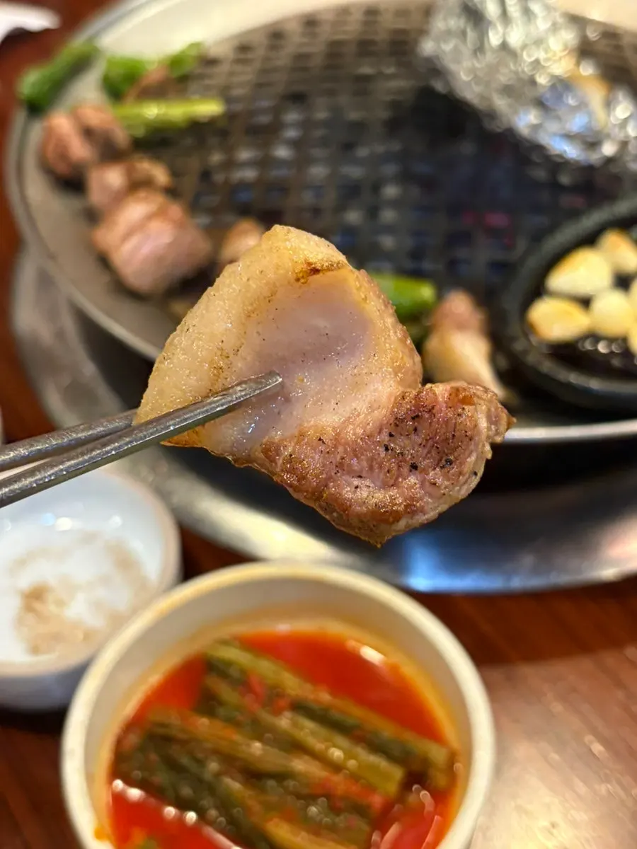 A piece of pork neck dipped in shiitake salt