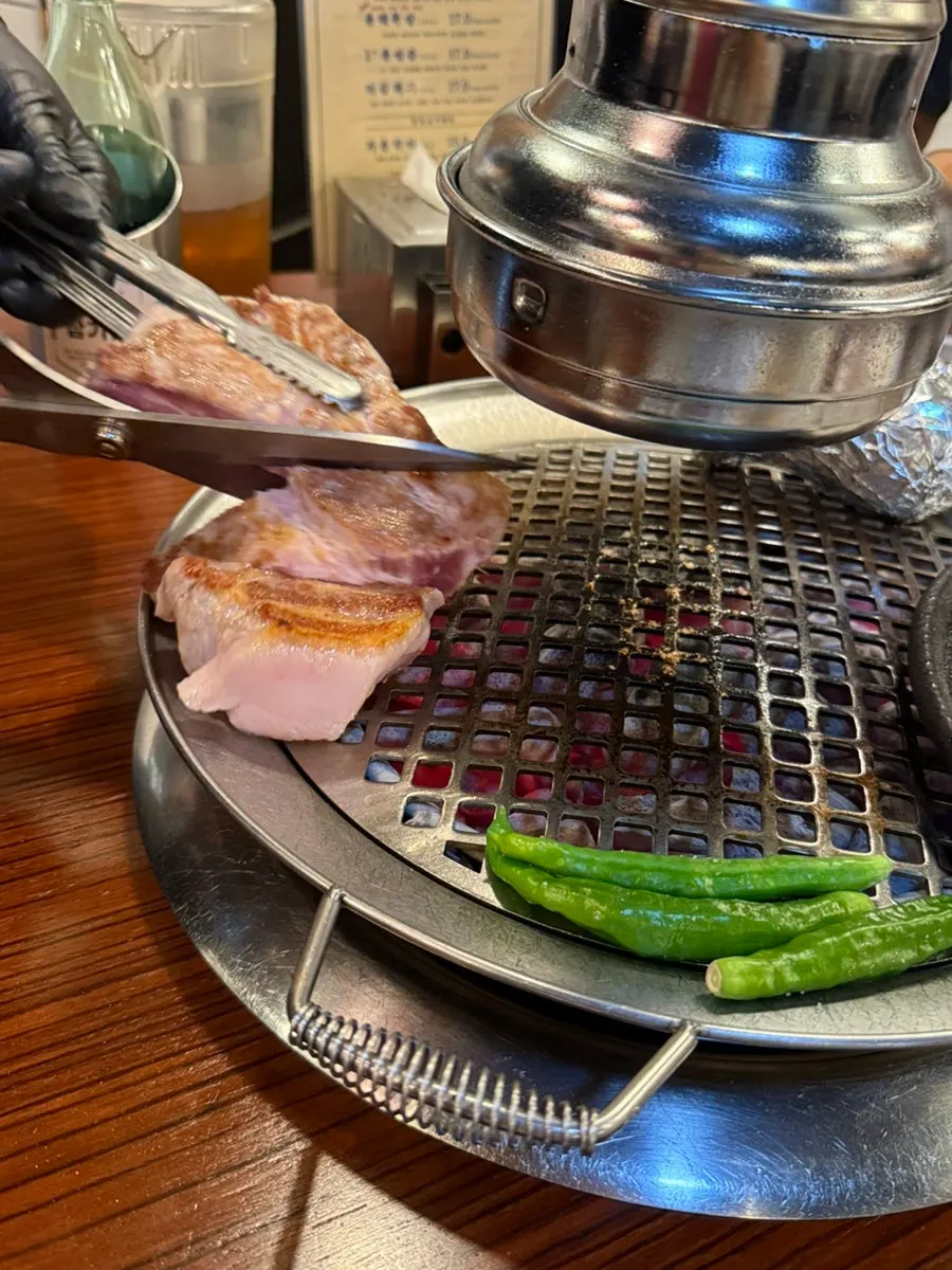 Staff grilling meat on the charcoal grill