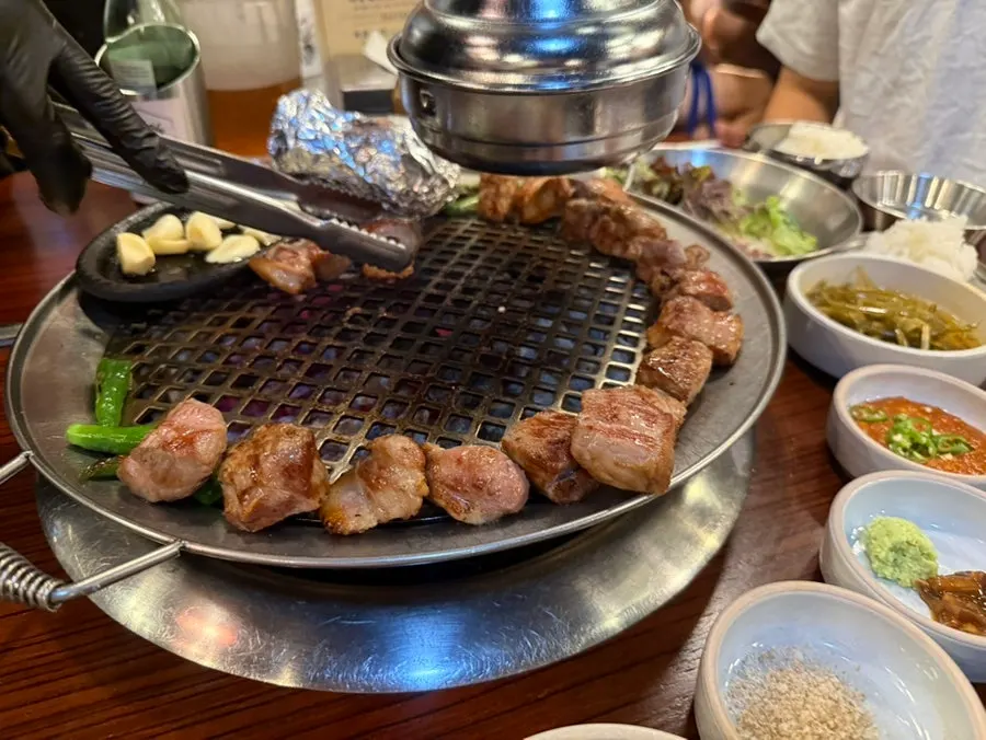 Thick pork with juices rising as it grills