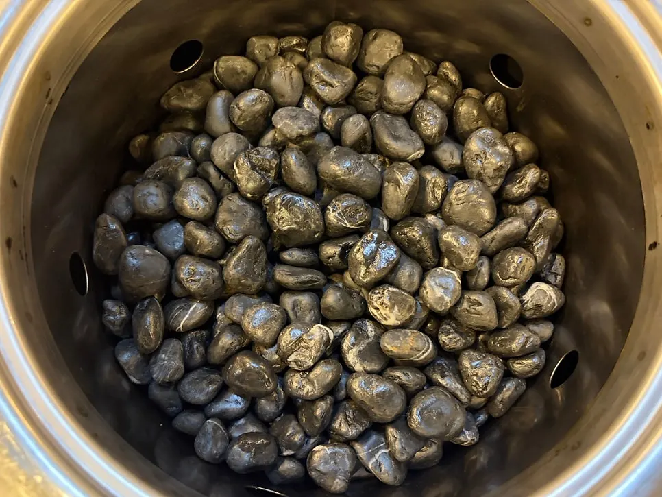 White charcoal in a pebble-filled brazier