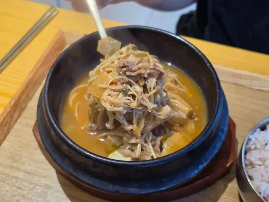 Beef brisket doenjang jjigae rice table with three side dishes