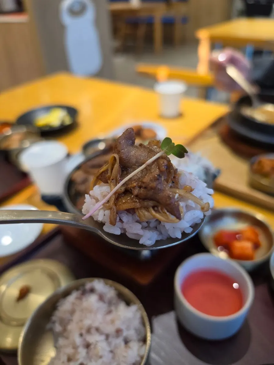 Shredded cabbage cooking alongside the dwaeji bulgogi