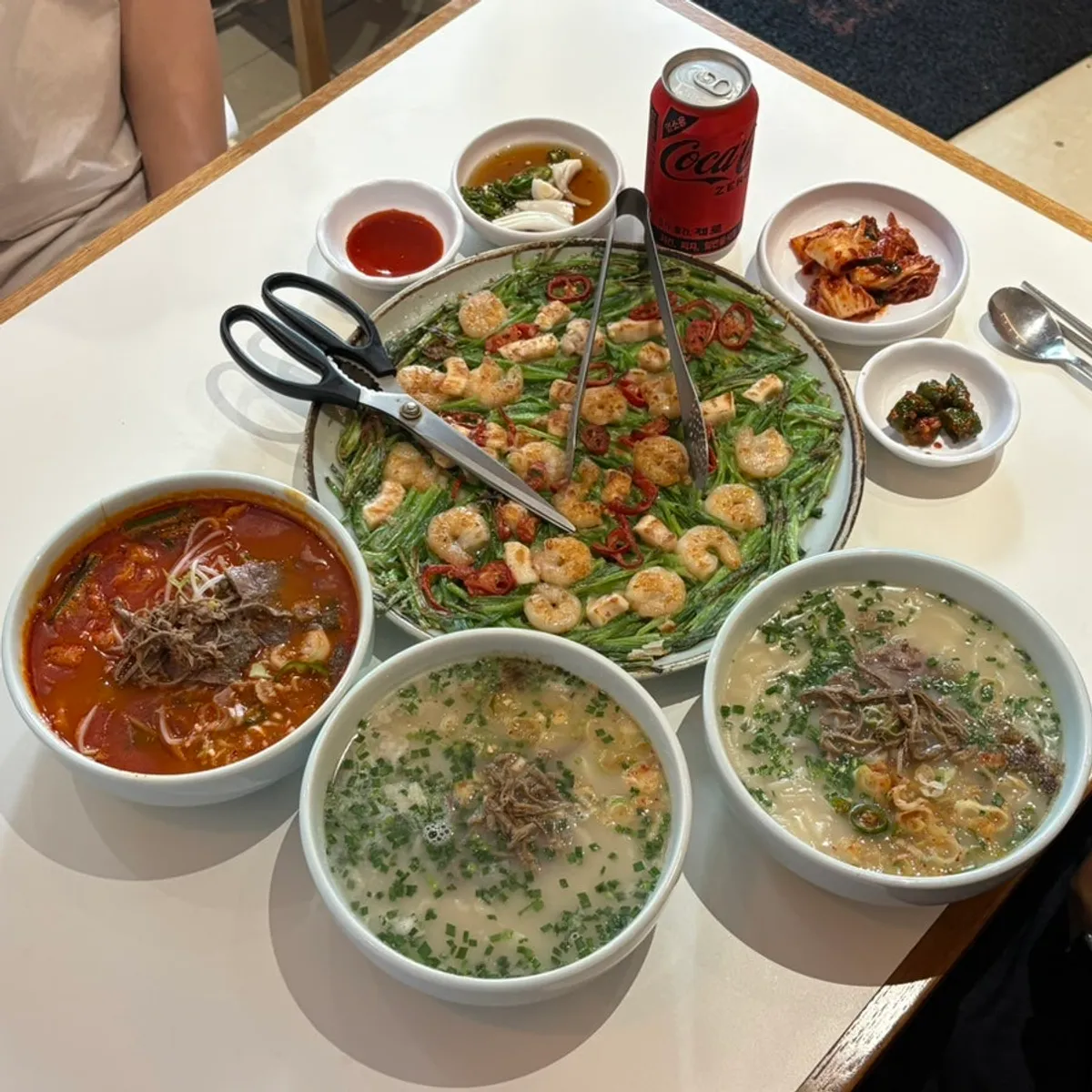 Table spread of kalguksu and the giant seafood chive pancake