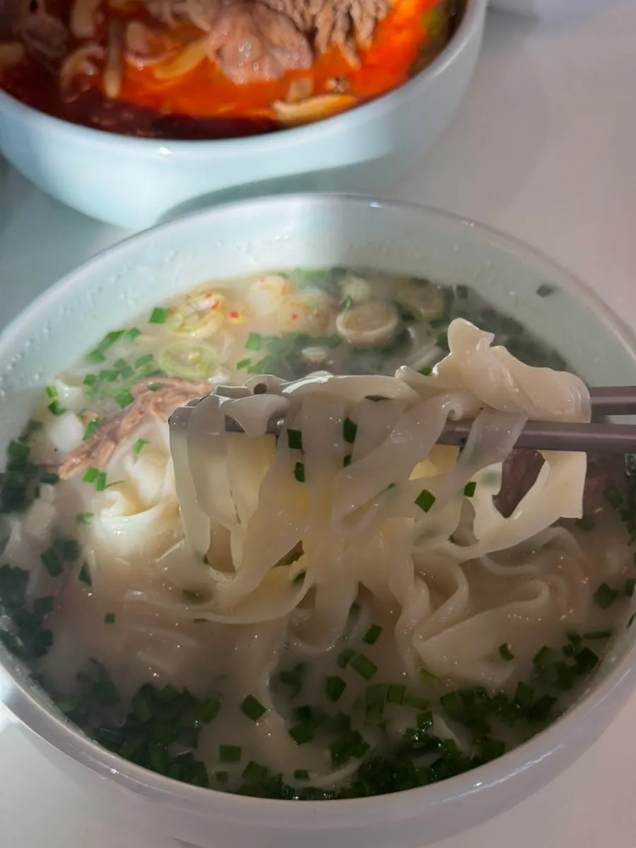 Kalguksu noodles being lifted up