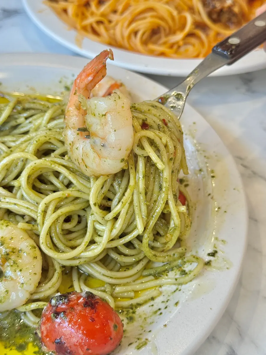 Close-up of springy shrimp on top of the basil pasta