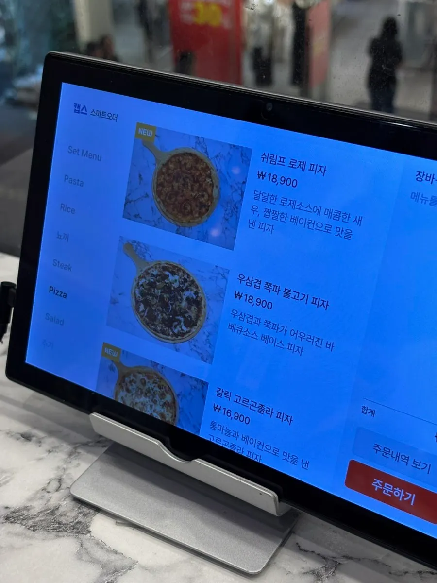 Menu board with pizza options and prices