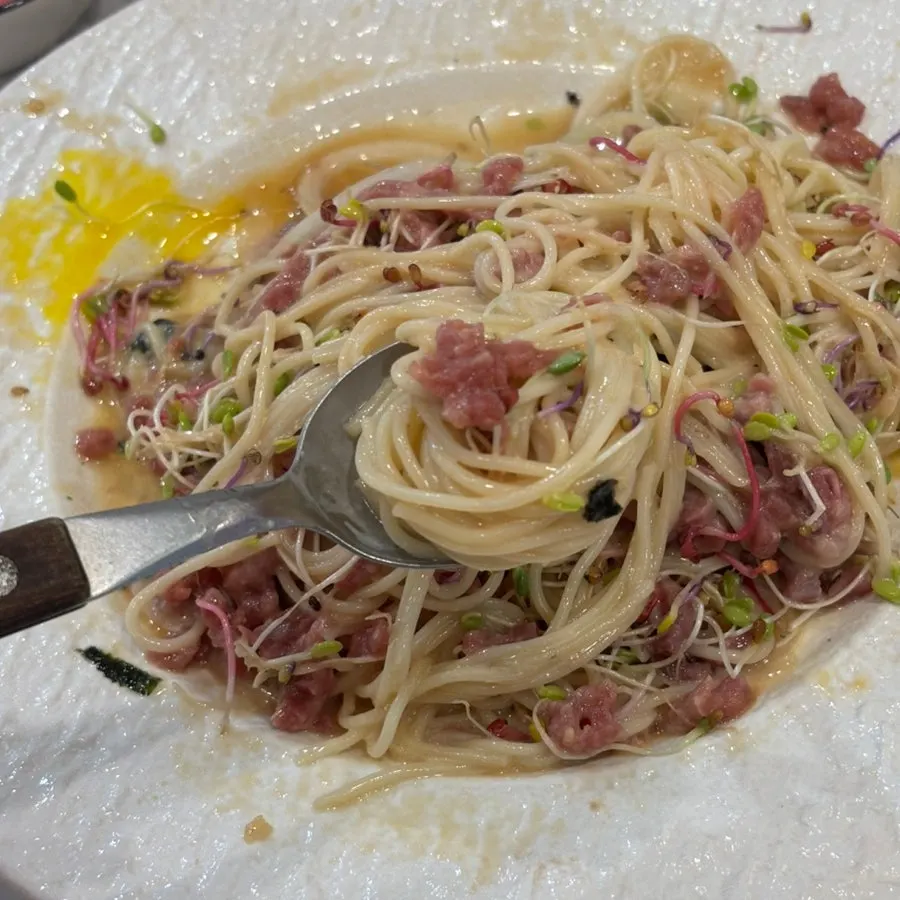 Perilla oil beef tartare pasta topped with sprouts