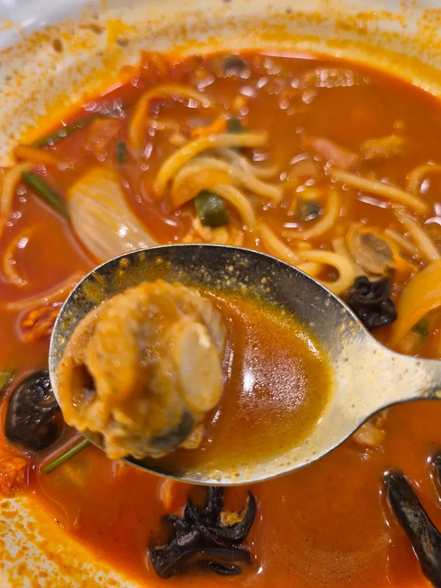 Close-up of cockle jjamppong with scallops mixed in