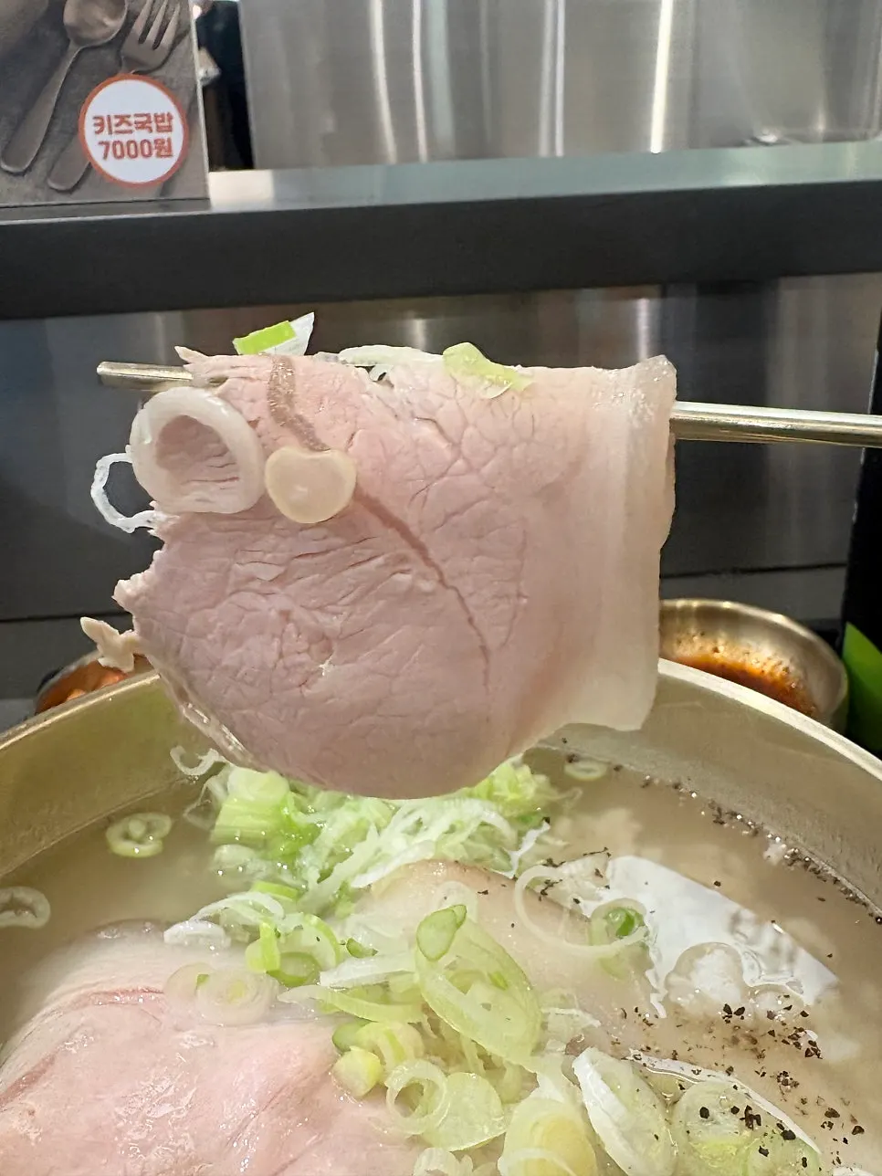 Close-up of pork gomtang with rice mixed into the broth
