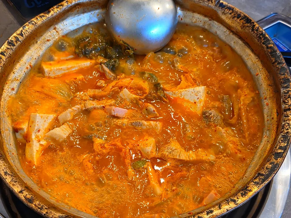 Kimchi jjigae served with a bowl of rice