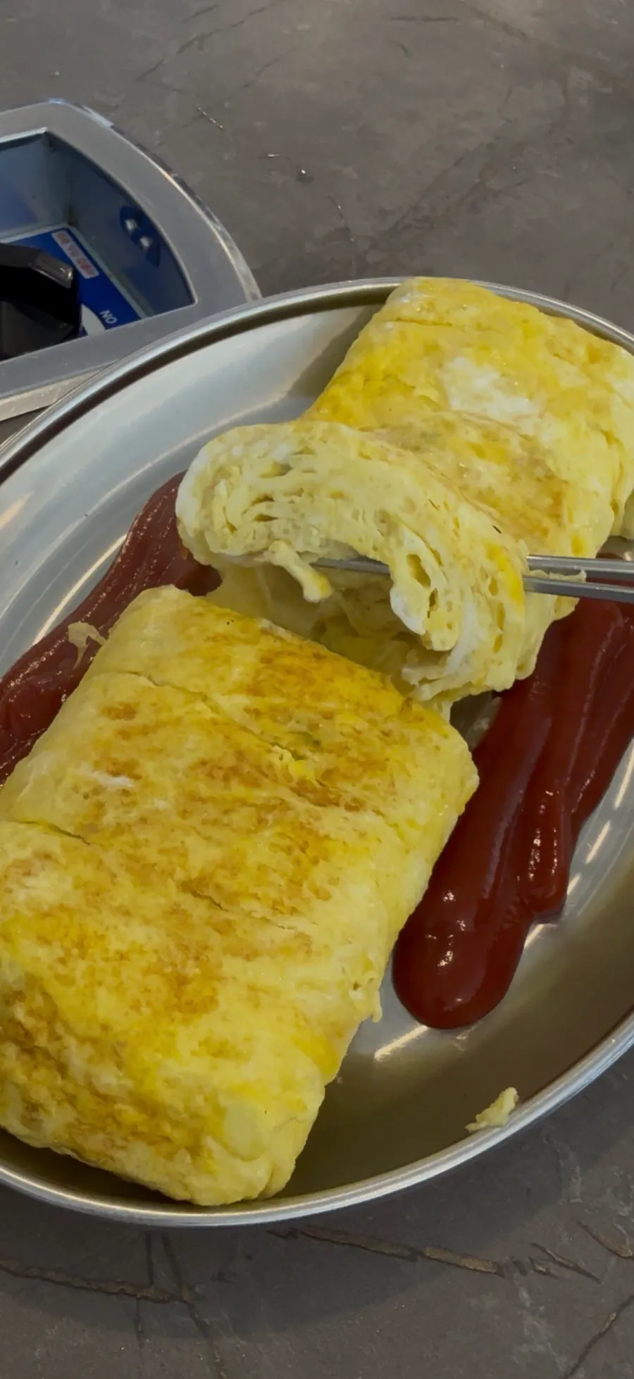 Close-up of the giant egg roll with ketchup