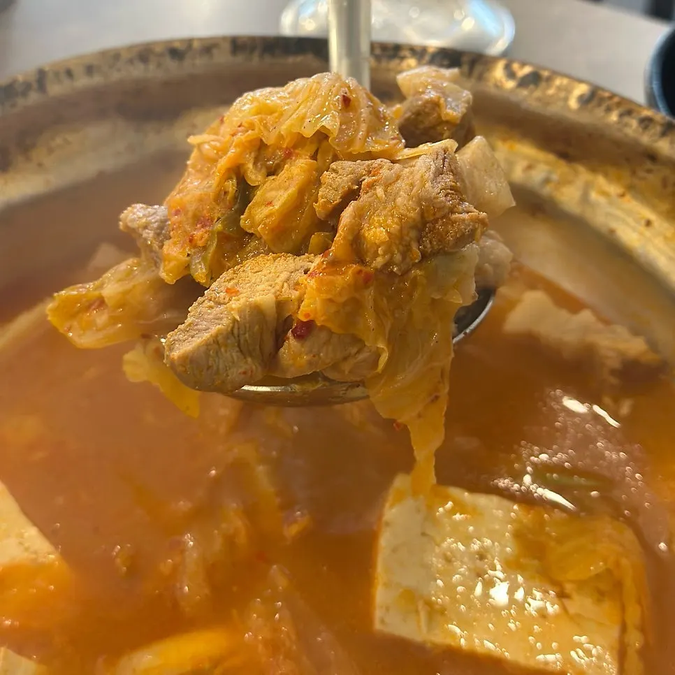Inside the kimchi jjigae showing generous tofu