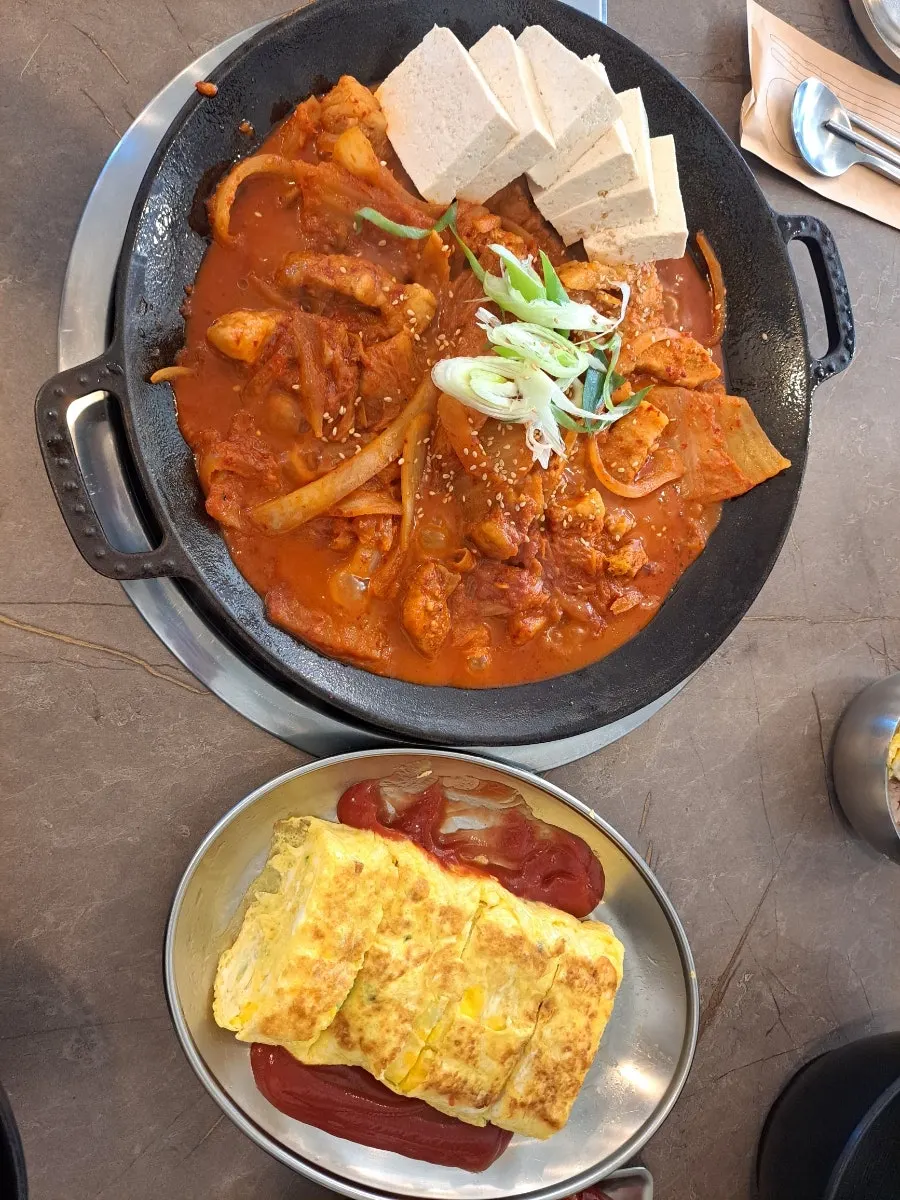 Kimchi jjim and egg roll set arrangement