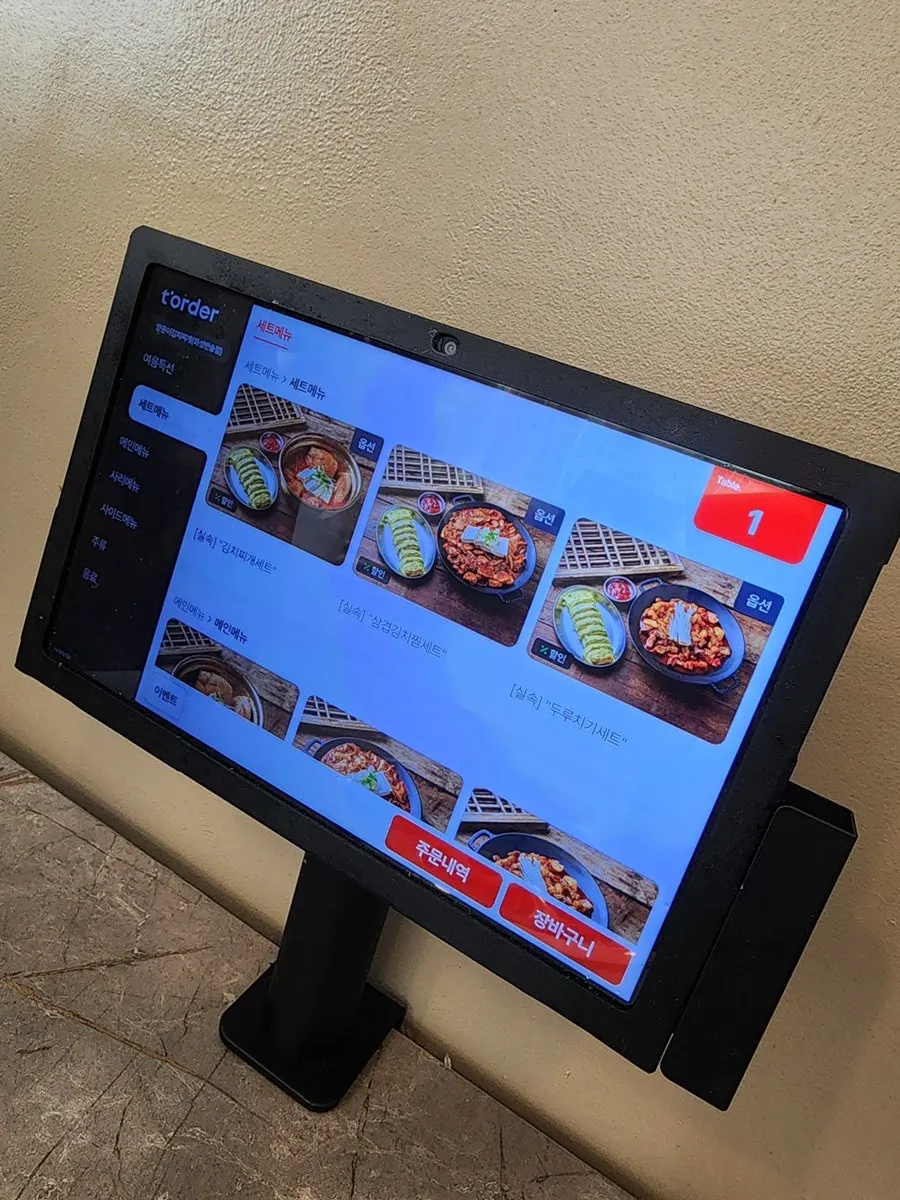 Menu board listing naengmyeon and side dishes